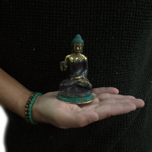 med hand up sitting buddha